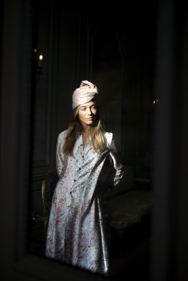 Model wearing Diana d'Orville sustainable luxury silk robe in light pink and seamless flower prints
