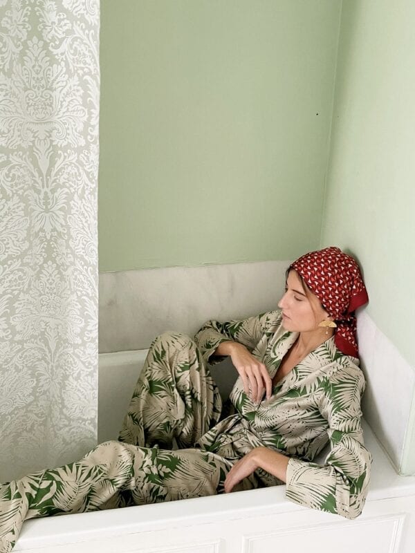 Ynes Ibarra in Diana d'Orville Sustainable Luxury palazzo set with green palm leaves prints on cream background